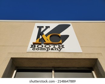 North Kansas City, Missouri, USA - April 9, 2022: Business Sign for KC BOOTH Company beneath Blue Sky
