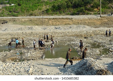 North Korea - May 3, 2019: Soldiers Of The North Korean People’s Army Mine And Transport Stones By Hands For Construction Work From Open Pit