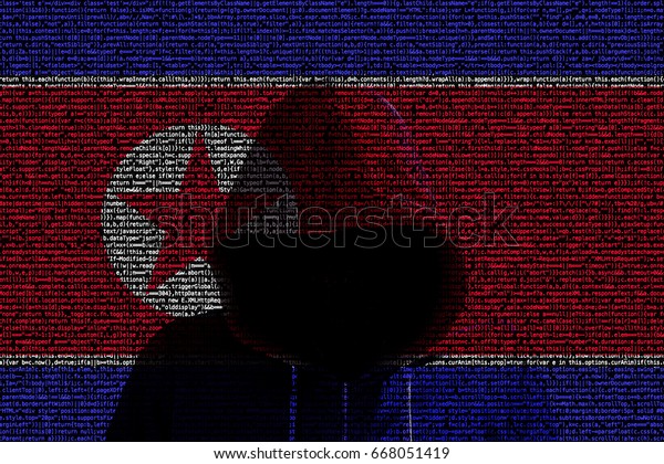 North korean flag made from\
computer code with a hooded hacker shining through cybersecurity\
concept