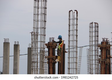 North Lombok-Indonesia, 12 February 2021. One Of The Construction Workers Is Working To Repair A Wooden Board For A School Building