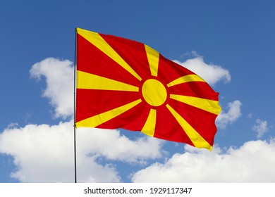 North Macedonia flag isolated on sky background with clipping path. close up waving flag of North Macedonia. flag symbols of North Macedonia.