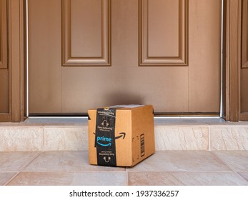 NORTH PORT, FLORIDA - MARCH 16, 2021: Amazon prime box delivered to residential doorstep. Amazon offers free package delivery to it's prime members.