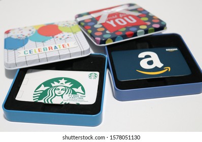North Port, Florida United States - December 3, 2019: Starbucks and Amazon gift cards in gift card boxes/holders
