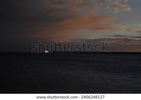 North Sea ferry entering the mouth of the River Tyne at sunrise on winter morning, North East England.