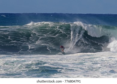 North Shore, Oahu, Hawaii, USA, December 13, 2017: A Surfer Riding Through A Fierce Wave Tunnel On A Windy Day At Waimea Bay Beach