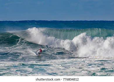 North Shore, Oahu, Hawaii, USA, December 13, 2017: A Surfer Riding Through A Fierce Wave Tunnel On A Windy Day At Waimea Bay Beach