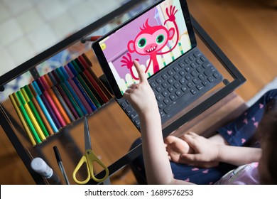 NORTH SYDNEY, NSWAUSTRALIA – MARCH 2020: Looking Down At A Young Girl Child Seated At Her Study Desk Learning School From Home With Ipad Tablet Education Program 