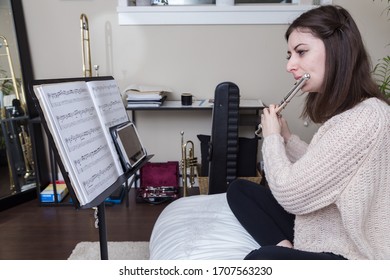 NORTH VANCOUVER, BC, CANADA - APR 16, 2020: A Young Woman Adapting To Self Isolation During The Covid 19 Pandemic By Teaching Students From Home.