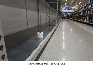 NORTH VANCOUVER, BC, CANADA - MAR 19, 2020: An Empty Shelf With A Single Roll Of Toilet Paper At A Supermarket As Panic Buying Grips The World As The Virus Spreads.