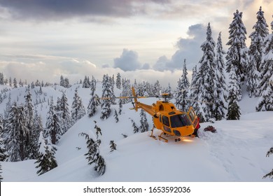 North Vancouver, British Columbia, Canada. North Shore Search and Rescue are rescuing a man skier in the backcountry of Seymour Mountain with a helicopter in winter during sunset.
