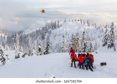 North Vancouver, British Columbia, Canada - Feb 17, 2020: North Shore Search And Rescue Are Rescuing A Man Skier With A Broken Leg In The Backcountry Of Seymour Mountain With A Helicopter In Winter.