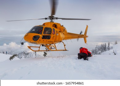 North Vancouver, British Columbia, Canada - Feb 17, 2020: North Shore Search And Rescue Are Rescuing A Man Skier With A Broken Leg In The Backcountry Of Seymour Mountain With A Helicopter In Winter.