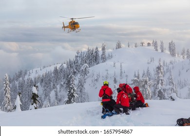 North Vancouver, British Columbia, Canada - Feb 17, 2020: North Shore Search And Rescue Are Rescuing A Man Skier With A Broken Leg In The Backcountry Of Seymour Mountain With A Helicopter In Winter.