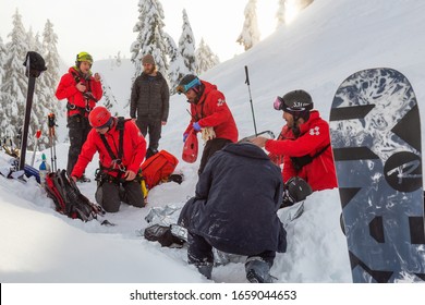 North Vancouver, British Columbia, Canada - February 17, 2020: North Shore Search And Rescue Are Rescuing A Man Skier With A Broken Leg In The Backcountry Of Seymour Mountain During Winter Evening.