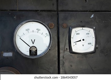 North Wales 5th Sept 2018 Two Old Volt Meters On Dark Plastic Wall Units With Rusty Bolts