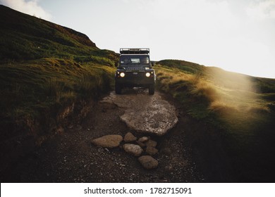 North Yorshire Moors, UK - July 23 2020: A Land Rover Defender off roading on a green lane in the North Yorkshire Moors in England.