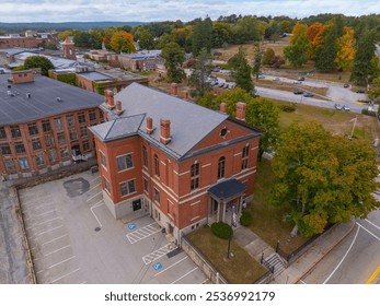 Northbridge town hall aerial view at 7 Main Street in fall with foliage in historic village of Whitinsville, town of Northbridge, Massachusetts MA, USA. 