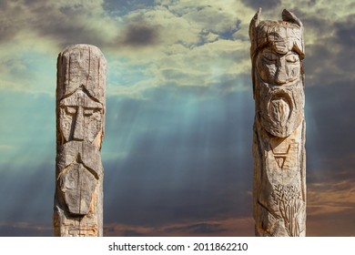 Northern lands. A pagan temple in the taiga with two wooden idols. The image of pagan gods is carved on wooden logs.