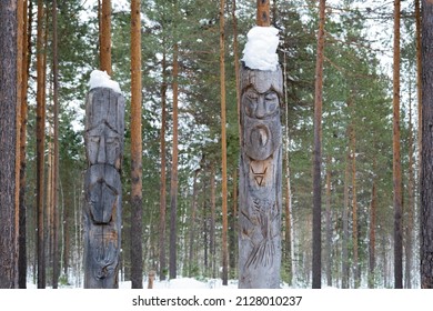 Northern Lands. A Pagan Temple In The Taiga With Two Wooden Idols. The Image Of Pagan Gods Is Carved On Wooden Logs.