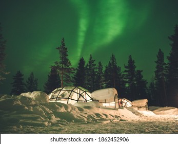 Northern in Lapland - Amazing Green Sky over glass IGLOO around snow and artic trees - Powered by Shutterstock