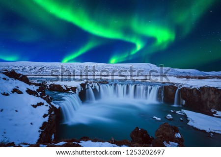 Northern Light, Aurora borealis at Godafoss waterfall in winter, Iceland.