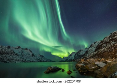 Northern Lights above waters edge - Shutterstock ID 262234709