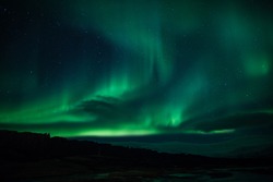 Northern Lights (Aurora Borealis) Over Lagoon In Iceland
