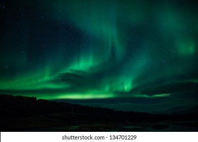 Northern Lights (Aurora Borealis) Over Lagoon In Iceland