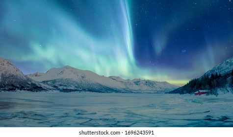 Northern lights or Aurora borealis in the sky over Tromso, Norway - Shutterstock ID 1696243591