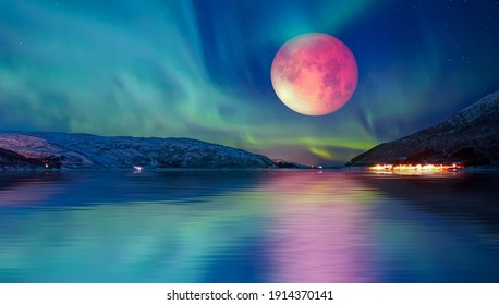 Northern lights (Aurora borealis) in the sky with lunar eclipse - Tromso, Norway "Elements of this image furnished by NASA"