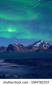 Northern Lights, Aurora Borealis With Star Trails Over The Rocky Mountains, Scenic Night Landscape, Lofoten Islands, Norway. Vertical Image