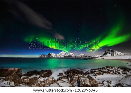 Northern lights explotion above Mt Himmeltinden in Lofoten archipelago