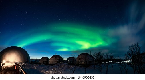 Northern Lights also known as aurora, borealis or polar lights at cold night over igloo village. Beautiful night photo of magic nature - Powered by Shutterstock