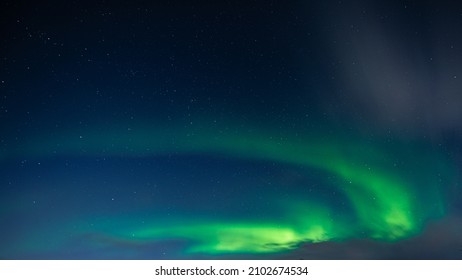Northern Lights also known as aurora, borealis or polar lights at cold night over deep black star sky. Beautiful night photo of magic nature phenomenon