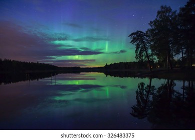 Northern Lights Over Calm Lake (Aurora Borealis) In Sweden, Unfocused Trees