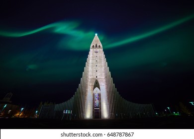 Northern lights shining over the church in Reykjavik Iceland