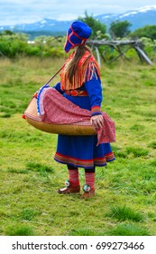 Northern Norway, A Traditional Dressed Sami Woman With A Cradle