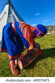 Northern Norway, A Traditional Dressed Sami Woman With A Cradle