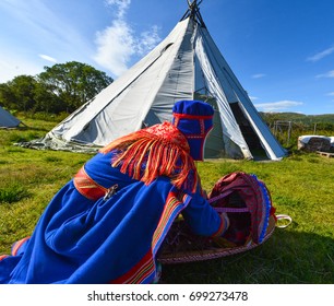 Northern Norway, A Traditional Dressed Sami Woman With A Cradle