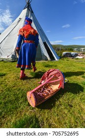 Northern Norway, A Traditional Dressed Sami Woman With A Cradle