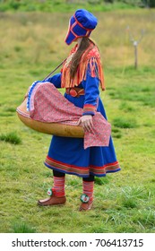 Northern Norway, A Traditional Dressed Sami Woman With A Cradle