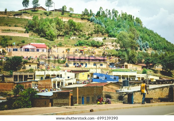 NORTHERN PROVINCE RWANDA -\
CIRCA FEBRUARY 2017: The whole town is out doing their marketing,\
socializing, singing and going to church on Sunday in a town in the\
countryside.