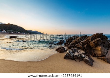 Northern side of Jeongdongjin sandy beach and its rocks at sunset, Gangneung, Gangwon-do,South Korea.