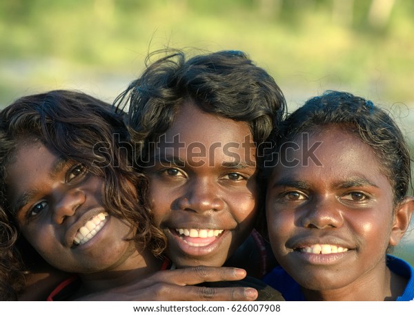 NORTHERN\
TERRITORY, AUSTRALIA - APRIL 29 2009: Three Aboriginal kids smiling\
for the camera in Northern Territory,\
Australia