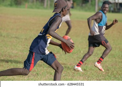 NORTHERN TERRITORY, AUSTRALIA - FEBRUARY 1 2009: Aboriginal Men Playing AFL (Australian Football Leauge) On A Community In Arnhem Land.