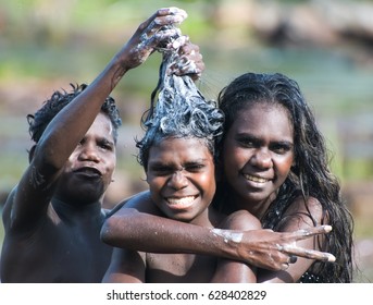 NORTHERN TERRITORY, AUSTRALIA - JANUARY 15 2009: Aboriginal Kids Washing Themselves In The River In Arnhem Land, Northern Territory, Australia.