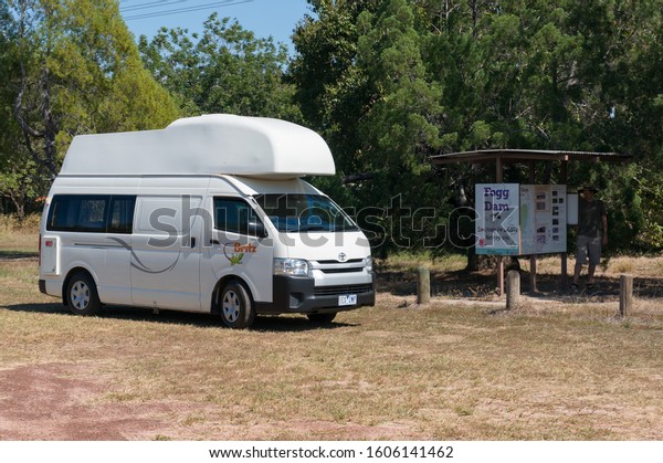 Northern Territory, Australia -\
June 2, 2019: White motorhome, campervan vehicle parked at\
information sign at Fogg Dam. Tourism Northern Territory, Australia\
