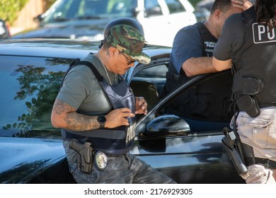 Northridge, California, United States -  June 29, 2022: A Multi-agency Task Force Including LAPD Narcotics Detectives Stages On A Community Street Prior To A Drug  Enforcement Raid Wearing Vests.