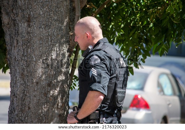 Northridge, California, United States -  June 29,\
2022: A multi-agency task force including LAPD Narcotics detectives\
stages on a community street prior to a drug policy enforcement\
raid.