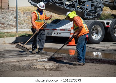 Northridge, California / USA -  September 25, 2019: L.A. Road Construction Crew Workers Repaving A Road In Suburban Los Angeles.